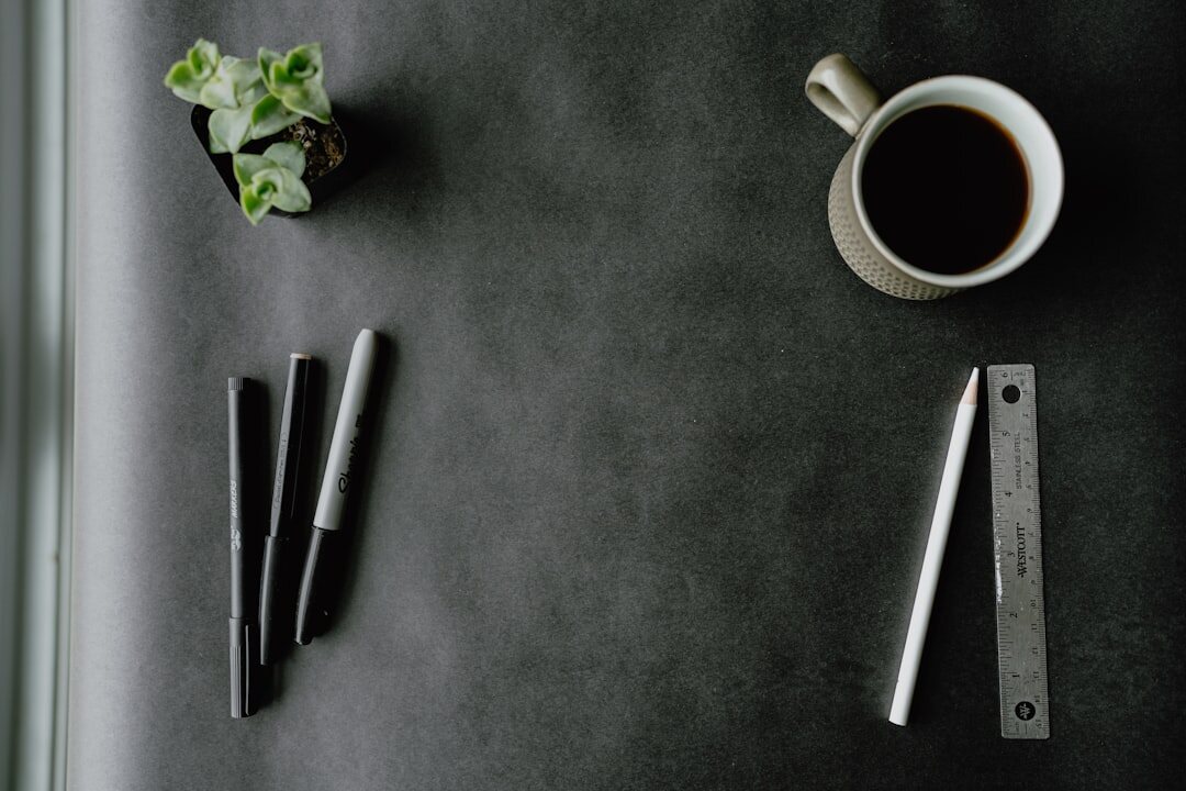 Calm minimalist desk with an open notebook, pen and a cup of tea