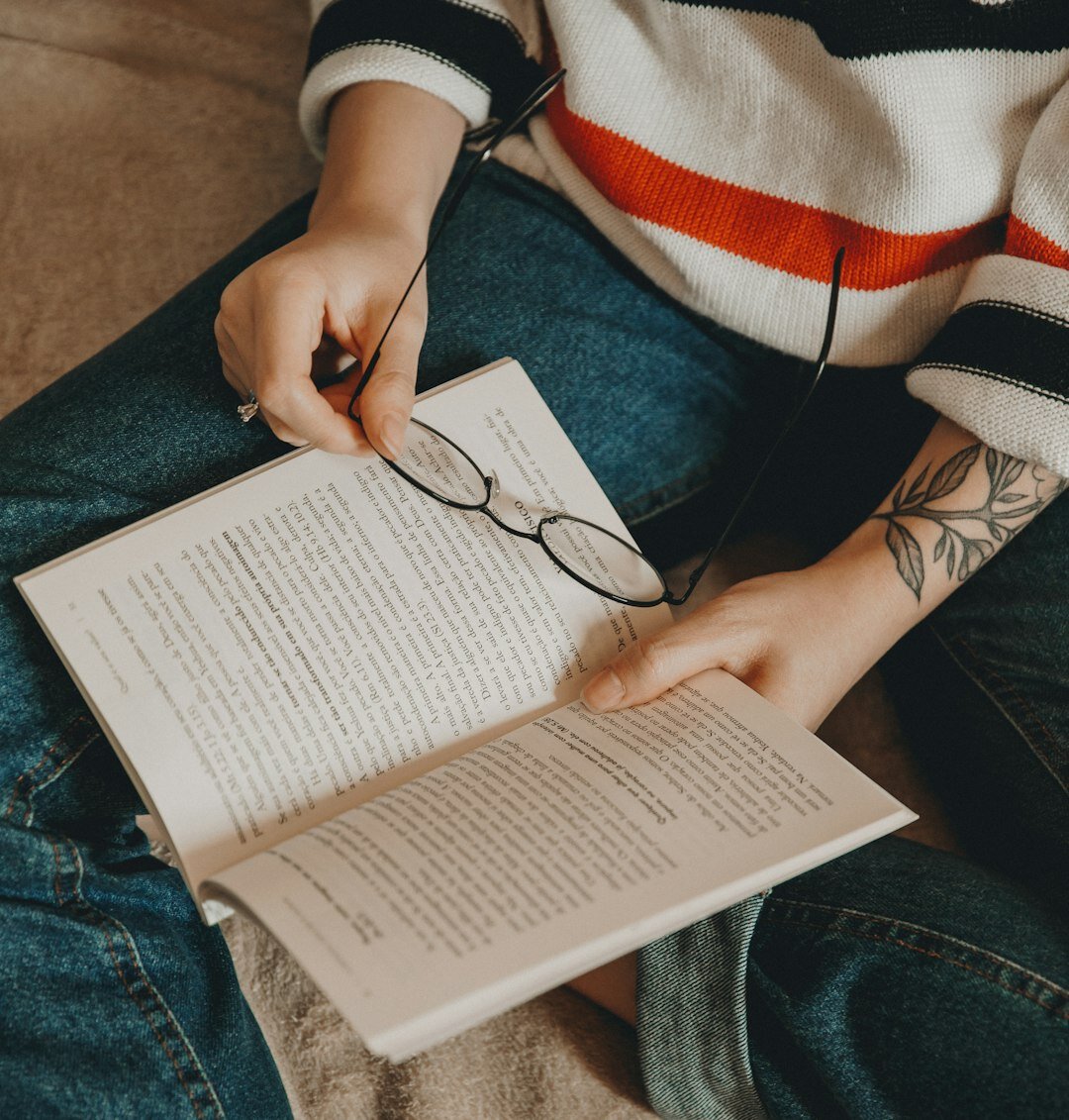 Brazilian woman writing thoughtfully in a journal at a wooden desk