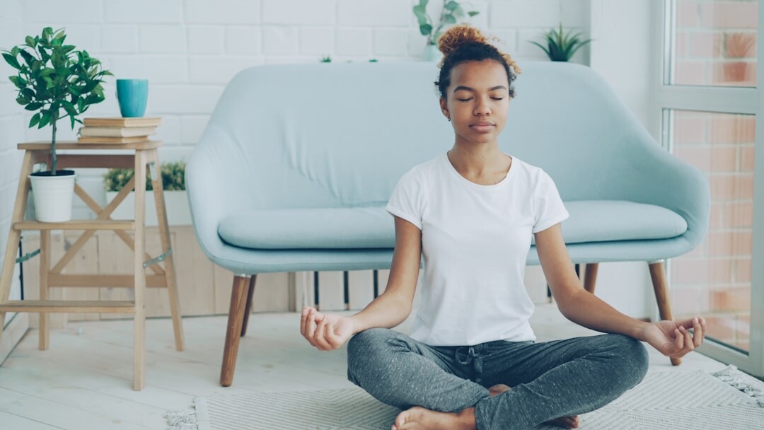 person meditating in calm room